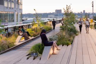 The benches look as if they are growing out of the ground and are a perennial design element. Source: Iwan Baan People sitting on benches